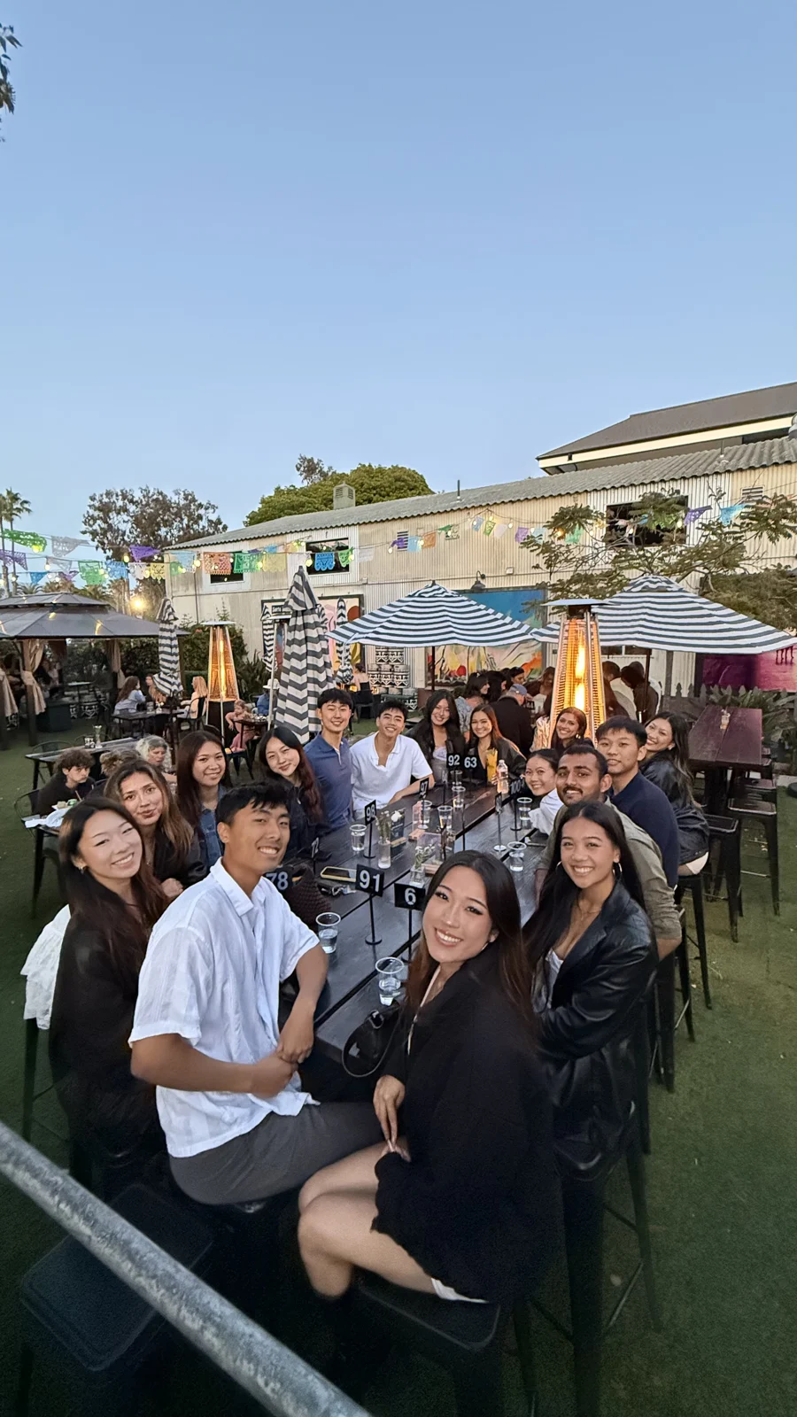 A group of friends gathered around an outdoor dinner table