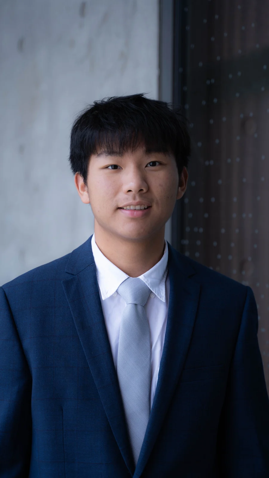 Portrait of Tony Xiao wearing a navy suit